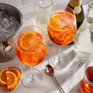 Coqueteis Aperol Spritz misturados com gelo, prosecco, agua com gas e fatias de laranja