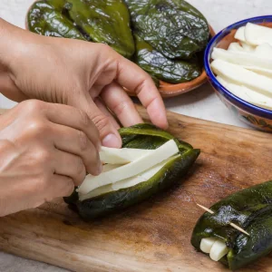 Roasted poblano peppers stuffed with thick strips of white cheese.