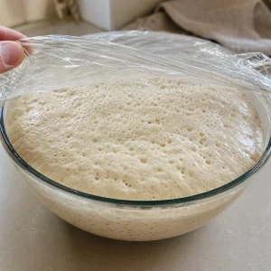 Bubbly ciabatta dough doubled in size after bulk fermentation