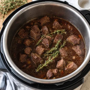 Beef bones brisket aromatics and spices in the pressure cooker