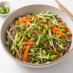 Soba noodles mixed with cucumber, carrots, edamame, and green onions