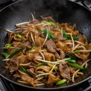 Beef, bean sprouts, and scallions tossed with rice noodles