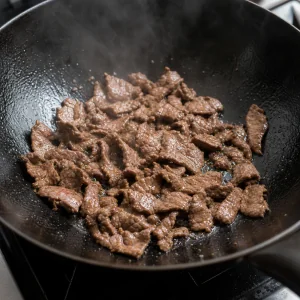 Beef slices searing in a hot wok