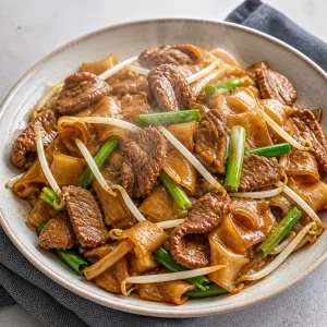 Hot beef chow fun served on a plate