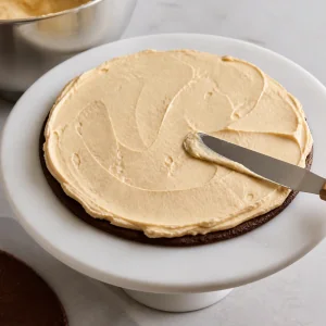 Peanut butter cream spread over the first chocolate wafer layer