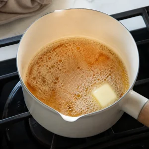 Browned butter foaming in a saucepan until light amber
