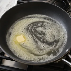 Butter melted and foaming in a non-stick skillet without browning