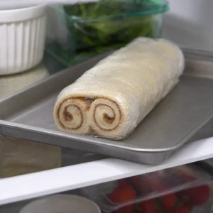 The double spiral pastry log is wrapped and chilled before slicing
