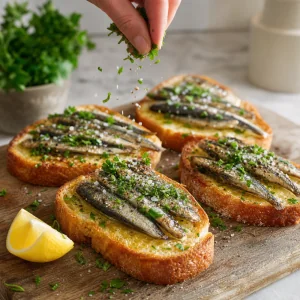 Sprat toast sprinkled with parsley sea salt and black pepper