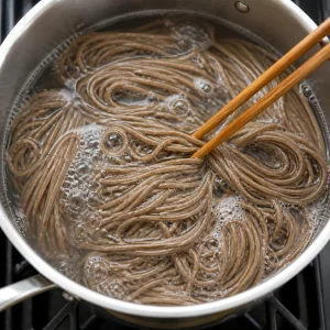 Soba noodles cooking in boiling water