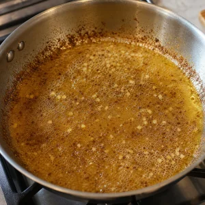 Broth simmering with browned pan bits