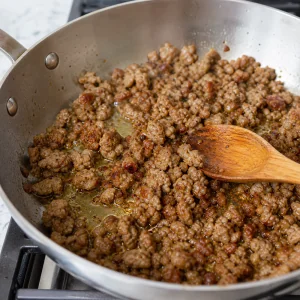 Spicy Italian sausage browned and broken apart in a skillet
