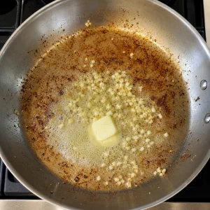 Butter and minced garlic sizzling in a skillet