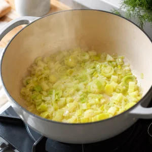 Onions and leeks softening in butter and olive oil in a large pot