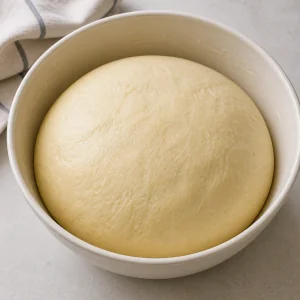 Risen kolache dough in a bowl