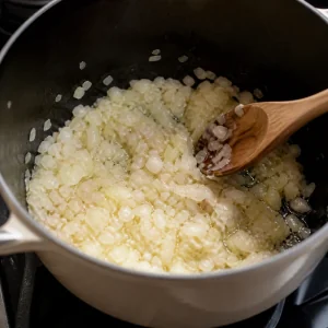 Onion and shallots softening in rendered fat