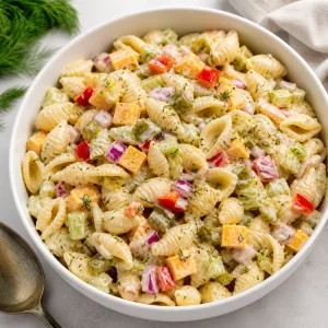 Finished dill pickle pasta salad in a white serving bowl