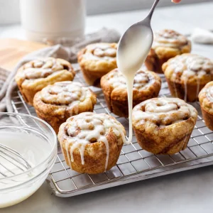 Fluffy keto cinnamon roll muffins with cream cheese glaze