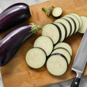 Eggplants sliced into even rounds on a cutting board