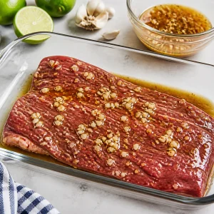 Flank steak marinating in garlic lime sauce