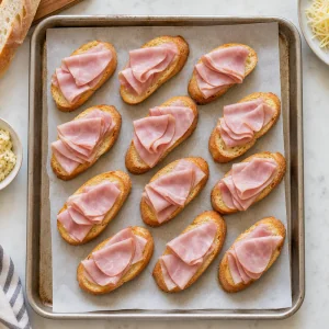 Folded ham on toasted garlic-butter baguette slices