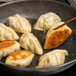 Vegetable dumplings frying until the bottoms are golden brown and crispy