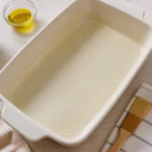 Lightly oiled rectangular baking dish ready for pastitsio.