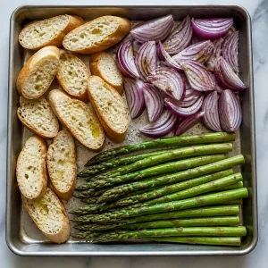 Baguette, red onion, and asparagus arranged for grilling