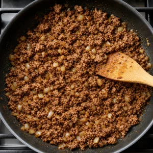Seasoned ground beef browned with onion in a skillet