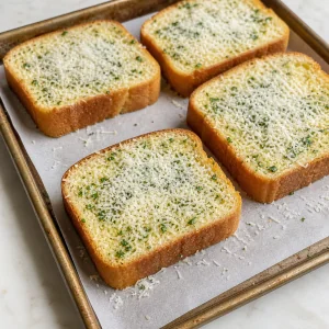 Parmesan sprinkled evenly over buttered garlic Texas toast slices