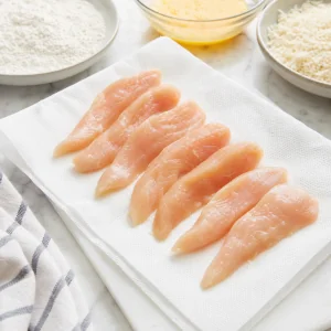 Chicken strips patted dry on paper towels before breading