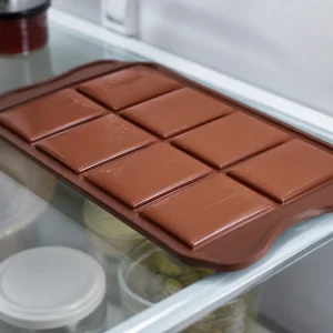 Sealed chocolate bars resting in the mold in the refrigerator until firm
