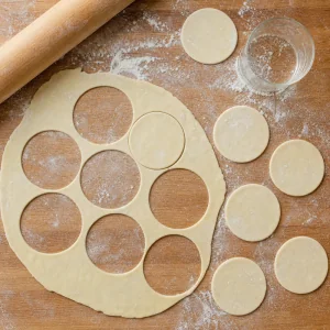 Thin pierogi dough rolled out and cut into round circles