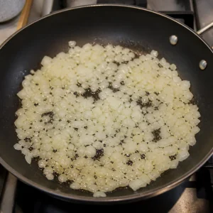 Chopped onion softening in oil in a skillet