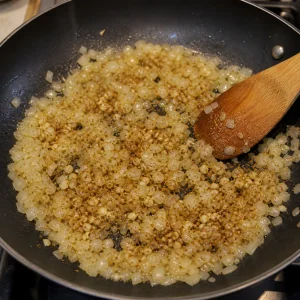 Garlic and cumin stirred into softened onions