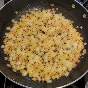 Chopped onion softening in a skillet