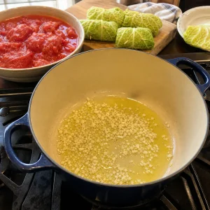Garlic cooking in olive oil with crushed tomatoes ready for the sauce