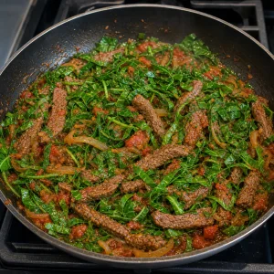 Fresh collard greens folded into tomato-sauced beef