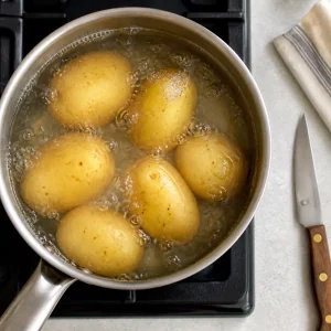Potatoes simmering in a saucepan of water