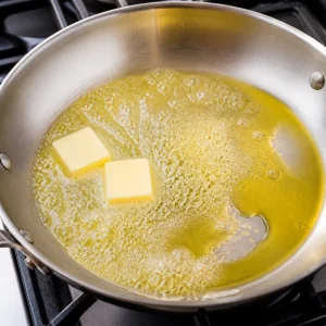 Butter melting with olive oil in a skillet for shrimp scampi sauce