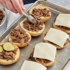 Steak and onions spooned onto rolls and topped with provolone