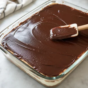 Chocolate ganache spread over the top cracker layer