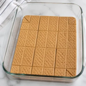 Graham crackers lining the bottom of a baking dish