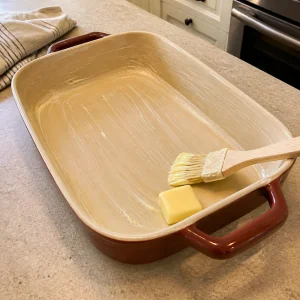 Buttered baking dish ready for sweet potato casserole