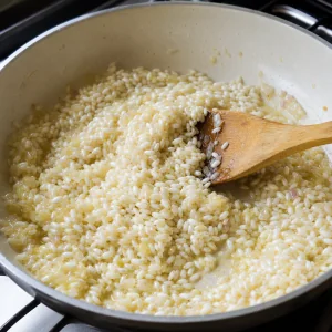 Arborio rice stirred into butter with shallot and garlic until glossy