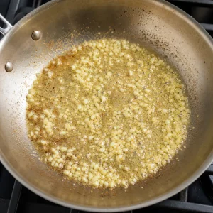 Minced garlic sauteing in melted butter