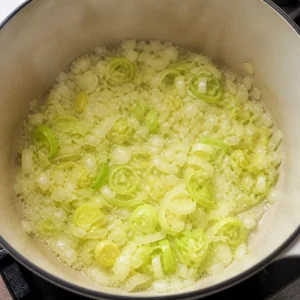 Chopped onion and sliced leek softening in butter