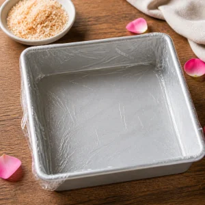 Plastic-lined square pan ready for milk jelly