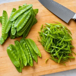 Snow peas cut lengthwise into thin ribbons