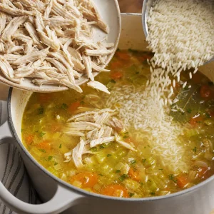 Shredded chicken being returned to the soup pot